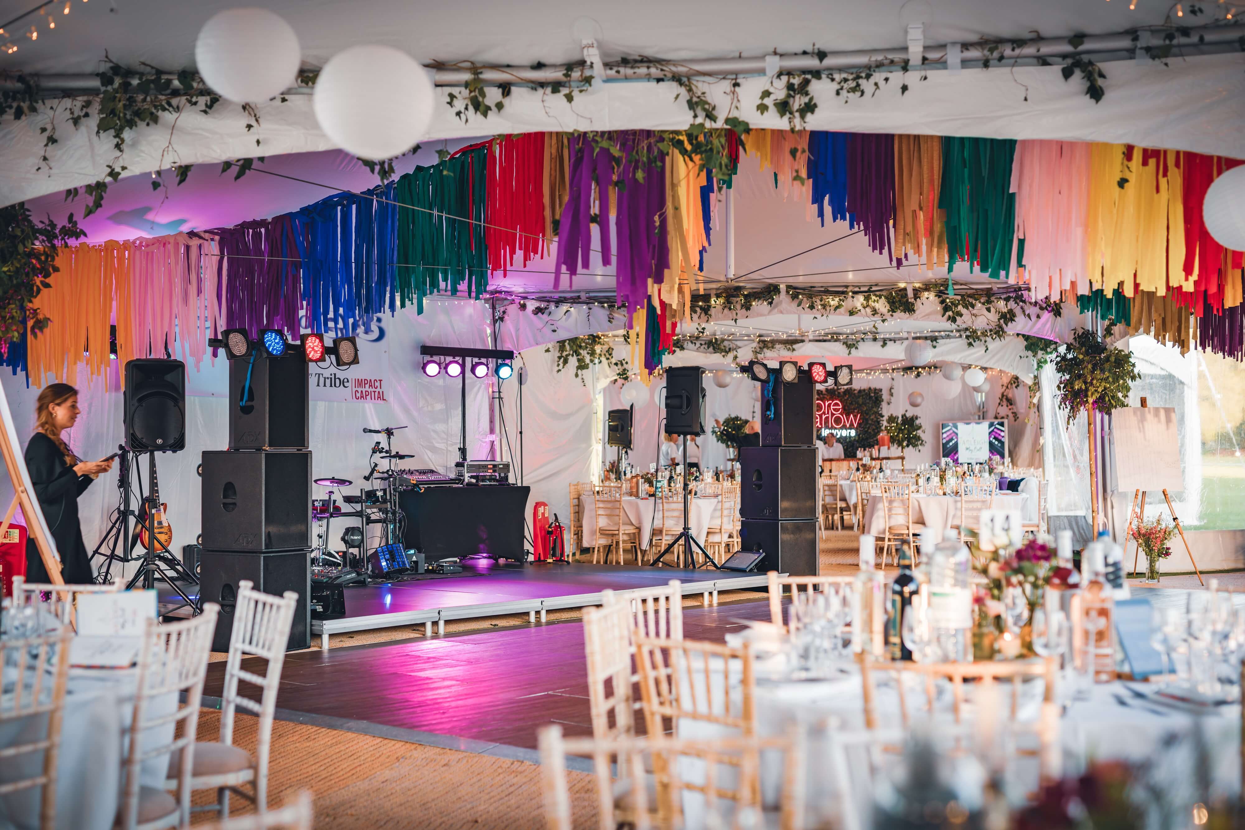 Inside a marquee with chairs and tables